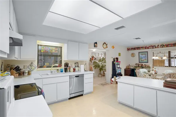a kitchen with a sink stove and cabinets