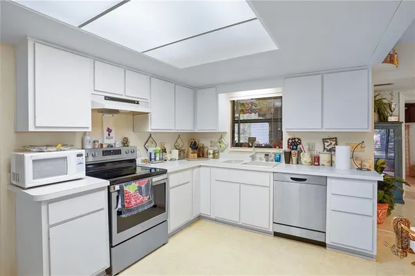 a kitchen with a sink a stove and cabinets