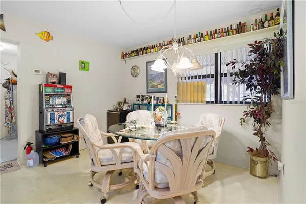 a dining room with furniture and a potted plant