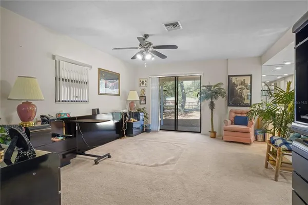 a work room with furniture and potted plants