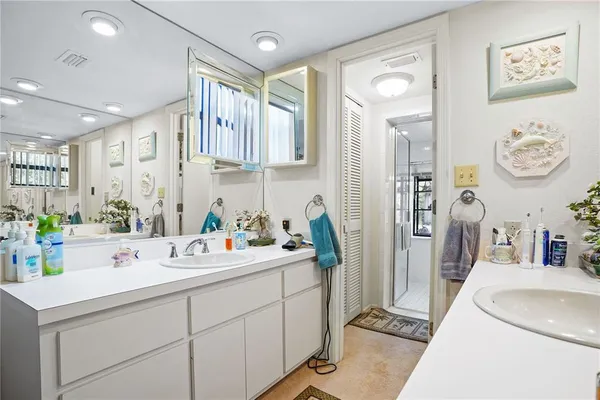 a bathroom with a sink a tub and a mirror