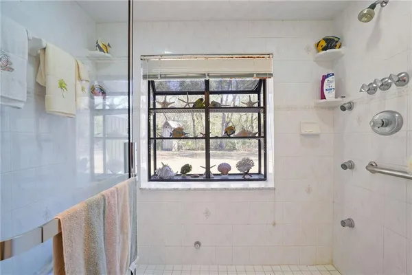 a bathroom with a window and a shower