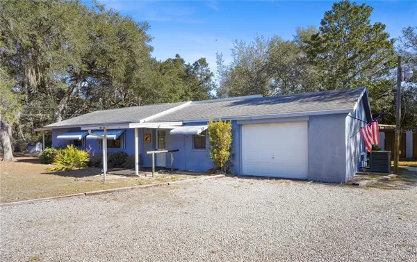 a view of a house with a yard and garage