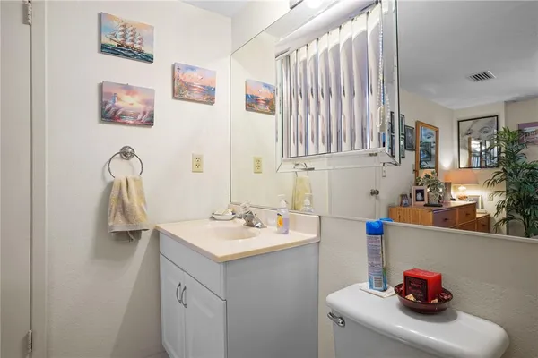 a bathroom with a sink vanity and a mirror