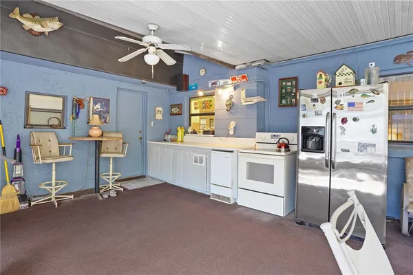 a view of a kitchen with fridge and workspace