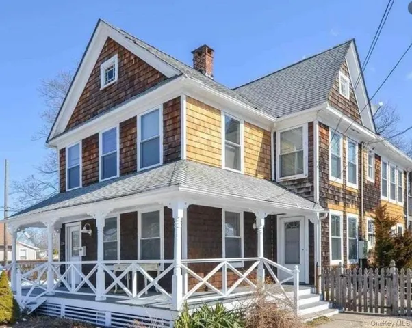 a view of a house with wooden fence