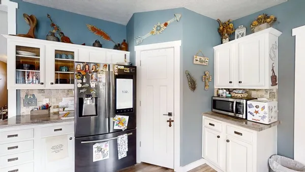 a kitchen with stainless steel appliances a refrigerator and cabinets