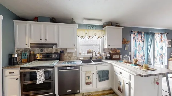 a kitchen with a sink stove and cabinets