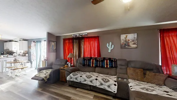 a bedroom with furniture and a large window