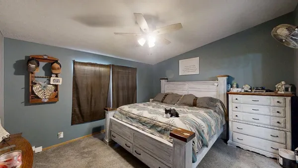 a bedroom with a bed and a dresser