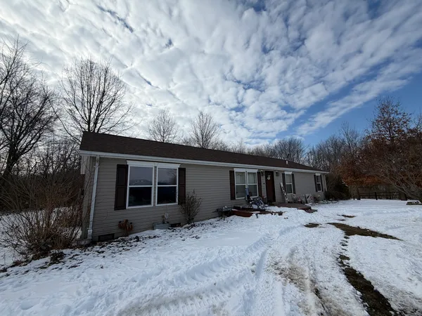 a view of house with snow on the road