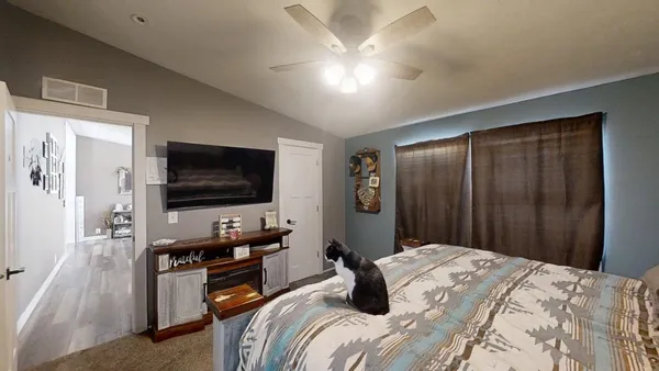 a bedroom with a bed and a flat screen tv