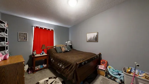 a bedroom with a bed and a tv