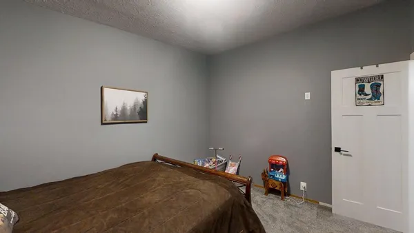 a bedroom with a bed and a table