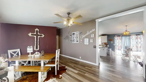 a view of a dining room with furniture wooden floor and chandelier