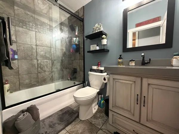 a bathroom with a sink toilet and shower