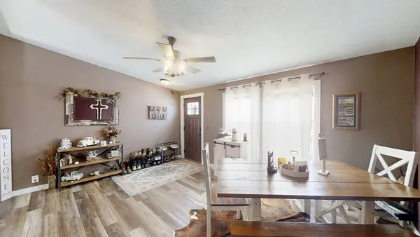 a view of a dining room with furniture and wooden floor