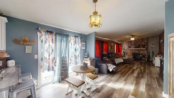 a living room with furniture and a chandelier
