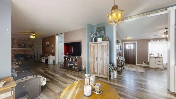 a living room with furniture and a chandelier
