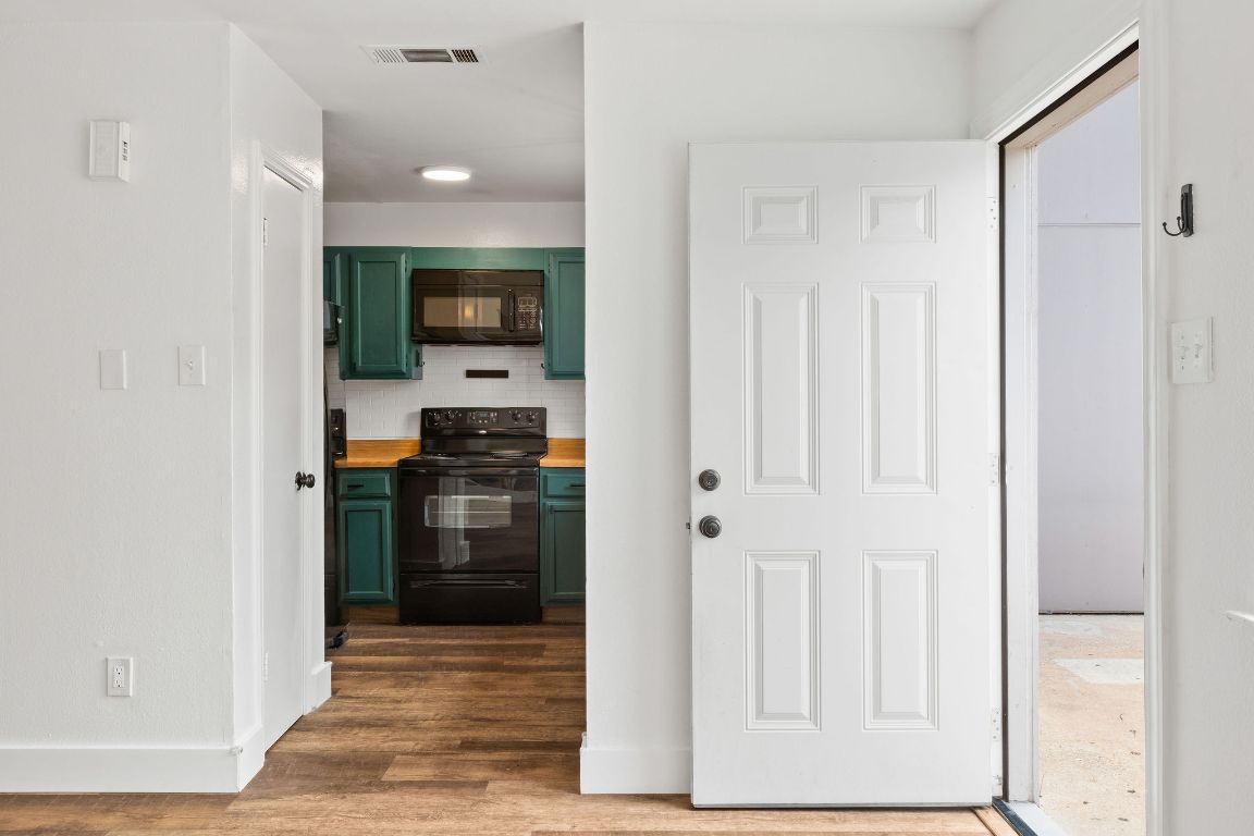 1712 Timber Ridge Road Austin, TX 78741 - Photo 12 of 35 Hall featuring dark wood-style floors and baseboards