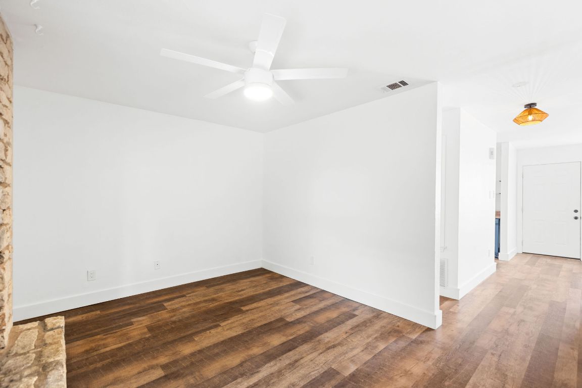 1712 Timber Ridge Road Austin, TX 78741 - Photo 19 of 35 Empty room featuring dark wood-style flooring and a ceiling fan