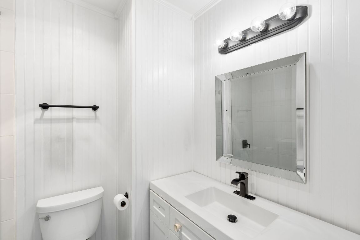 1712 Timber Ridge Road Austin, TX 78741 - Photo 28 of 35 Bathroom with vanity and ornamental molding