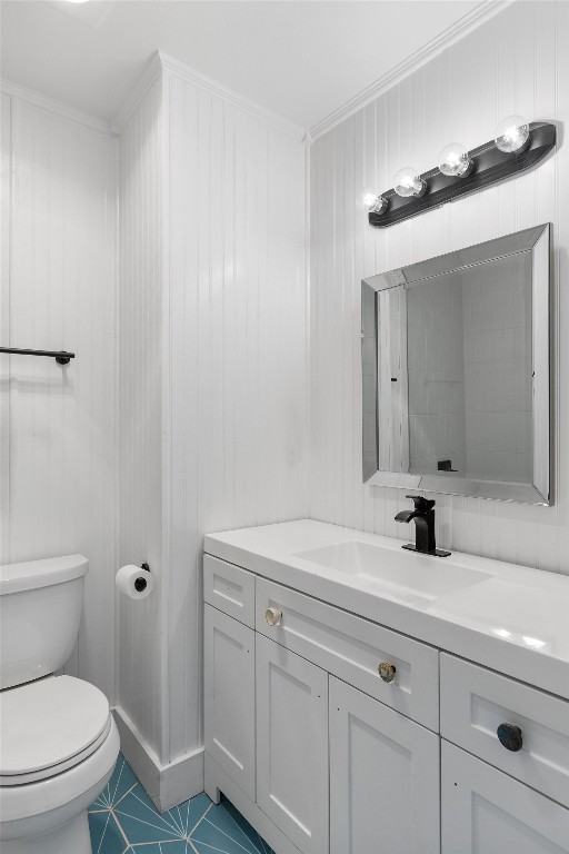 1712 Timber Ridge Road Austin, TX 78741 - Photo 30 of 35 Bathroom with vanity, wood walls, dark tile patterned floors, and crown molding