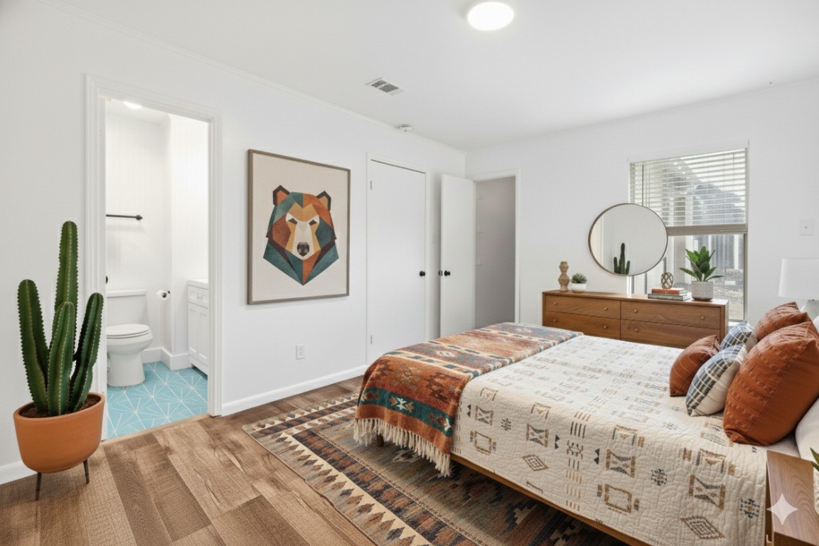 1712 Timber Ridge Road Austin, TX 78741 - Photo 6 of 35 Bedroom featuring wood finished floors and ensuite bath