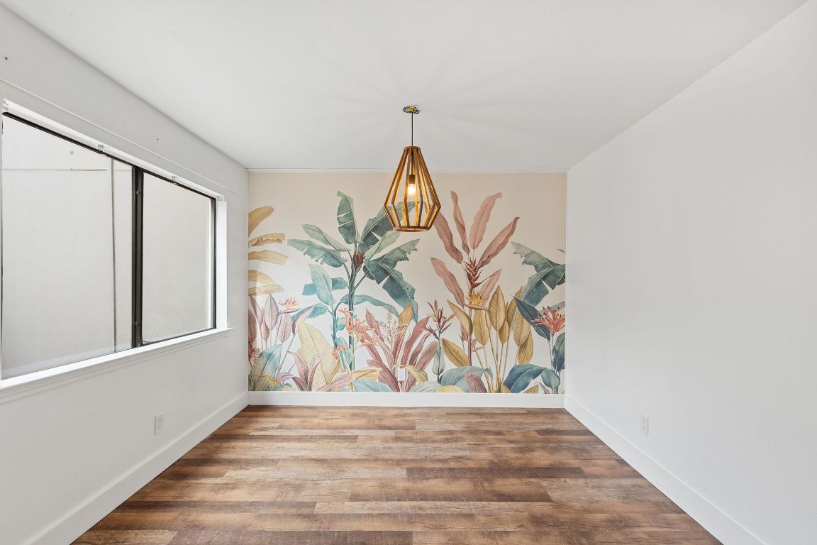 1712 Timber Ridge Road Austin, TX 78741 - Photo 10 of 35 Unfurnished dining area with wood finished floors