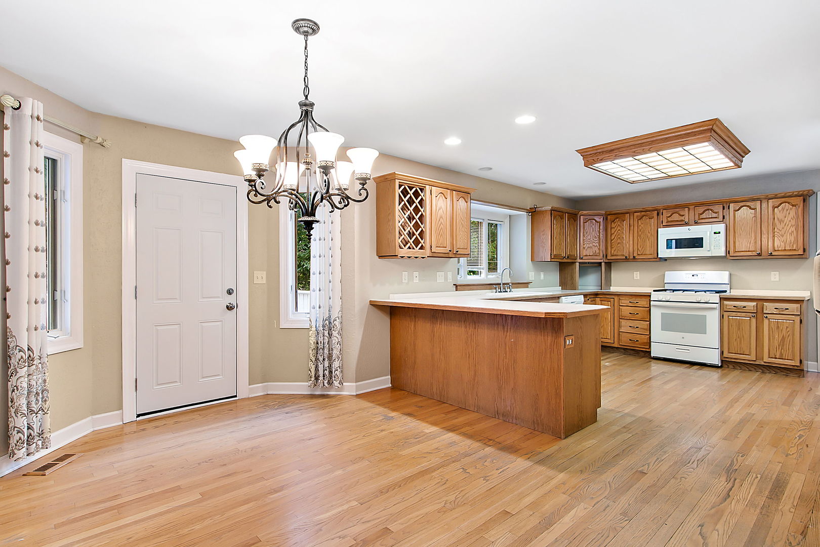 920 Merrill New Road Sugar Grove, IL 60554 - Photo 5 of 18 a kitchen with stainless steel appliances granite countertop a sink cabinets and wooden floor