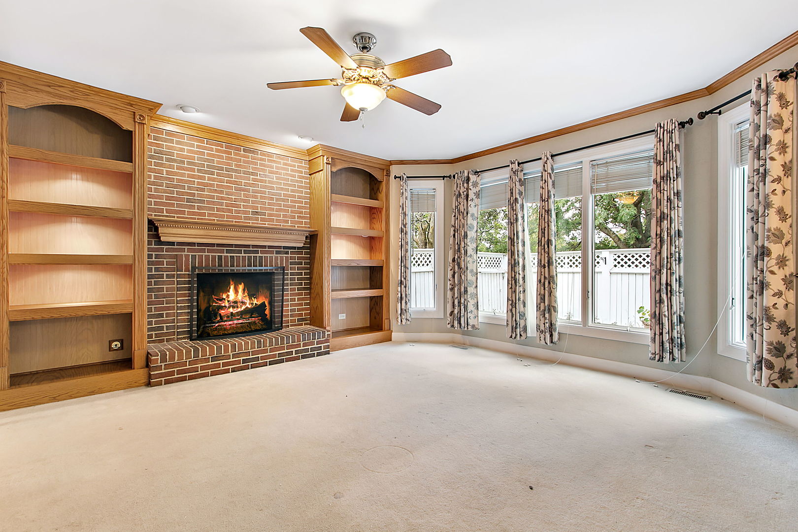 920 Merrill New Road Sugar Grove, IL 60554 - Photo 7 of 18 a view of an empty room with a fireplace and a window