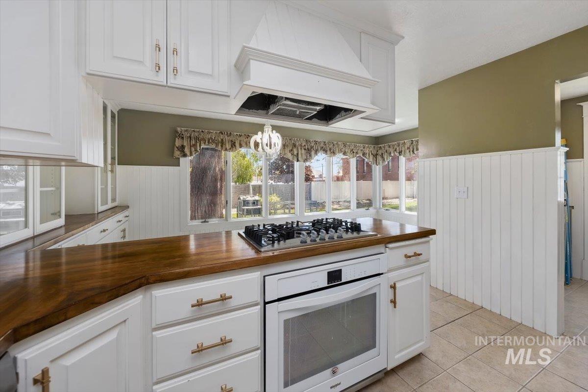813 7th Street Rupert, ID 83350 - Photo 20 of 48 Kitchen featuring white cabinetry with gold-tone hardware, wood-finish countertops, and a built-in oven with a gas cooktop