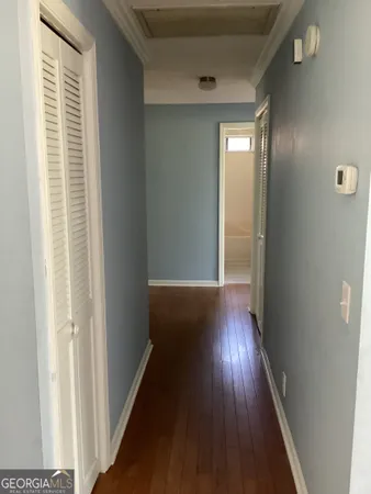a view of hallway with wooden floor