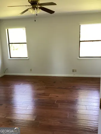 a view of room with window and wooden floor