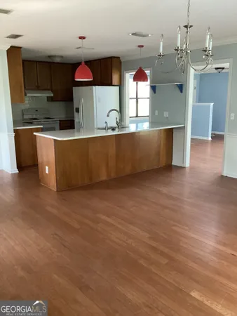a kitchen with stainless steel appliances wooden cabinets and a counter top space