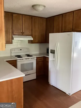 a white refrigerator freezer sitting in a kitchen