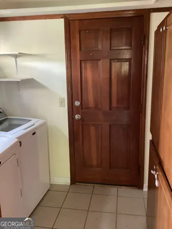 a view of a utility room with cabinets