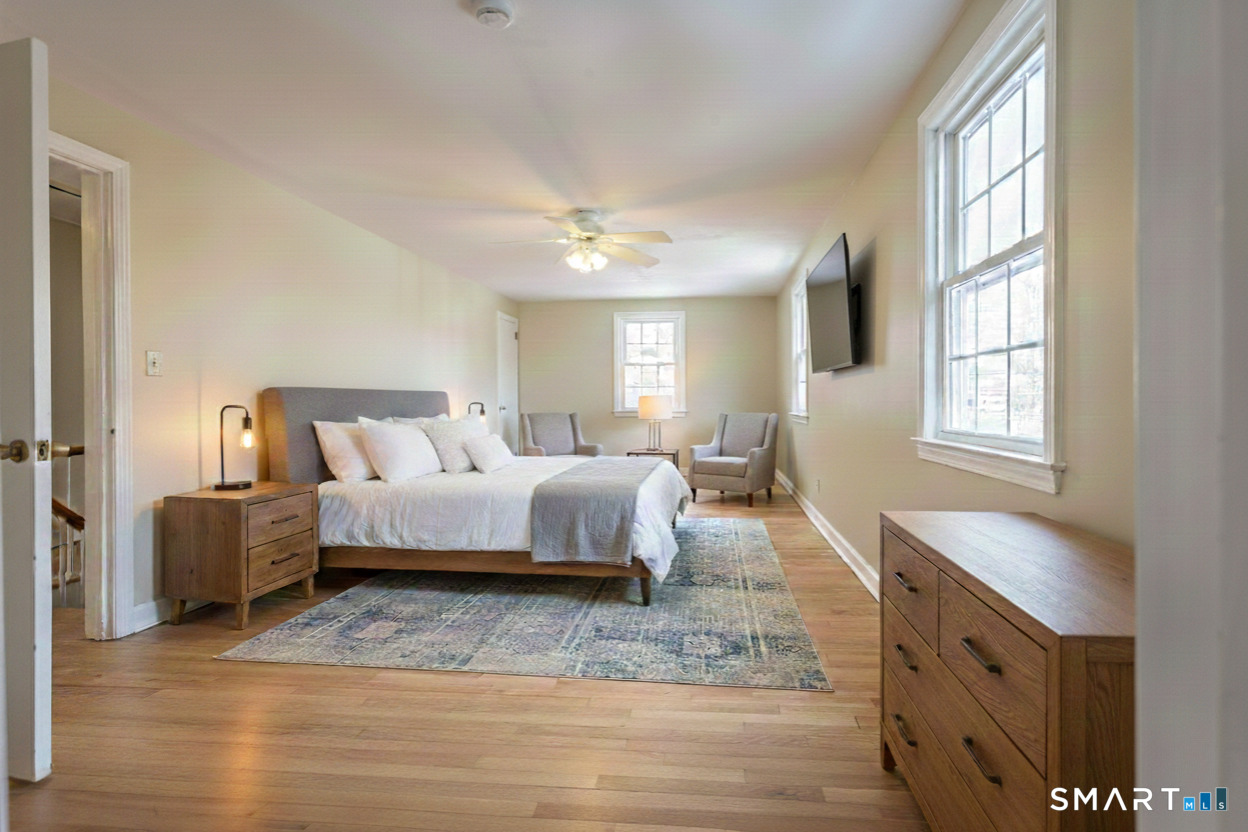 5 Lawler Road West Hartford, CT 06117 - Photo 17 of 33 a bedroom with a bed and a chandelier