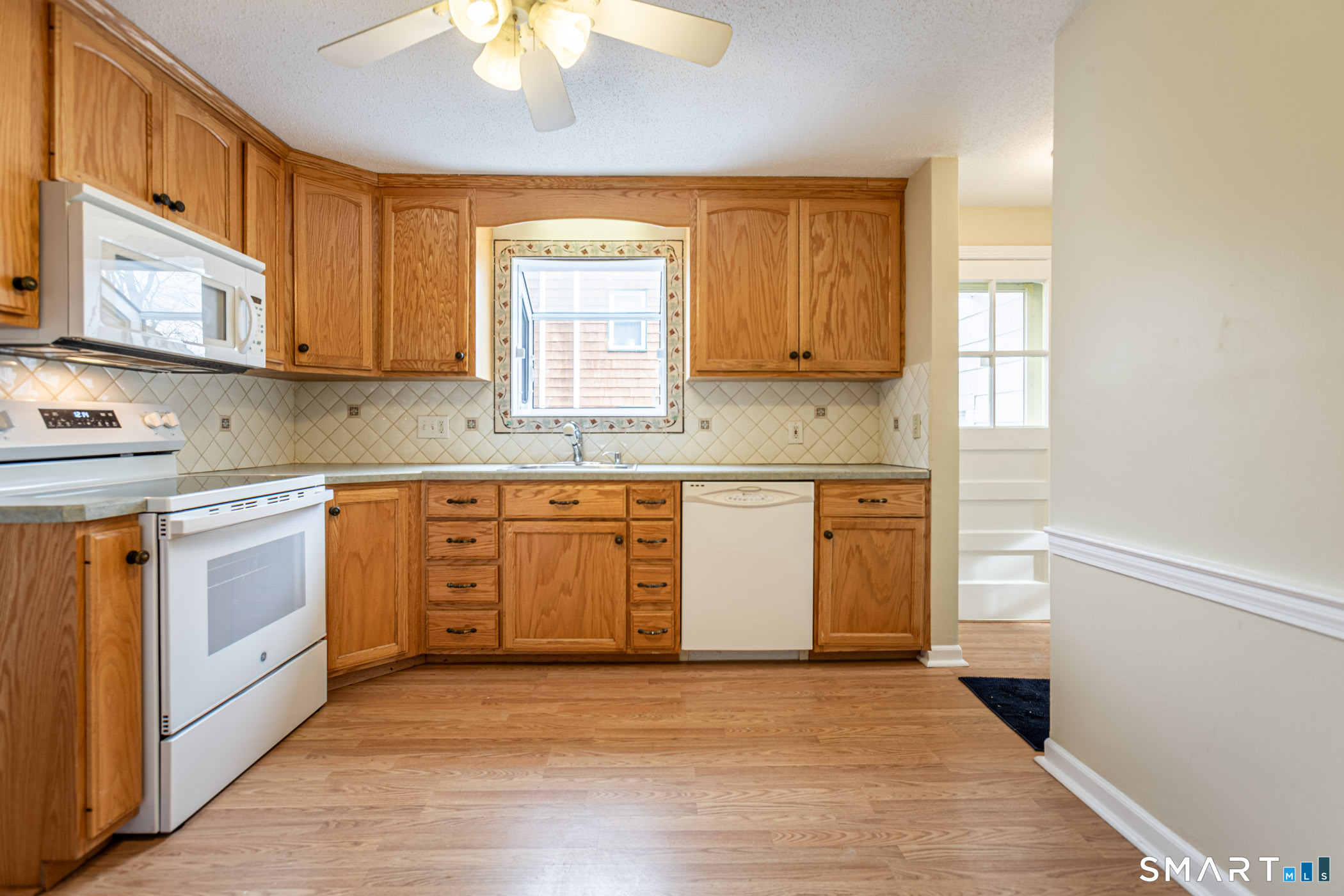 5 Lawler Road West Hartford, CT 06117 - Photo 30 of 33 a kitchen with stainless steel appliances granite countertop a stove a sink and a refrigerator