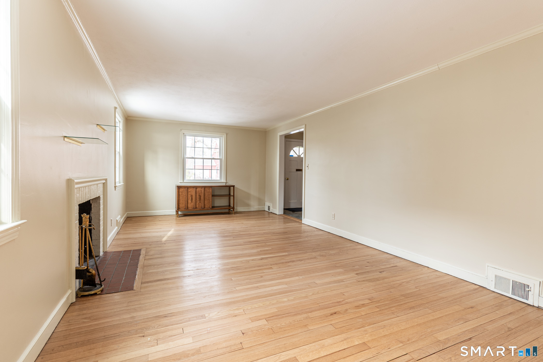5 Lawler Road West Hartford, CT 06117 - Photo 4 of 33 a view of empty room with fireplace and wooden floor