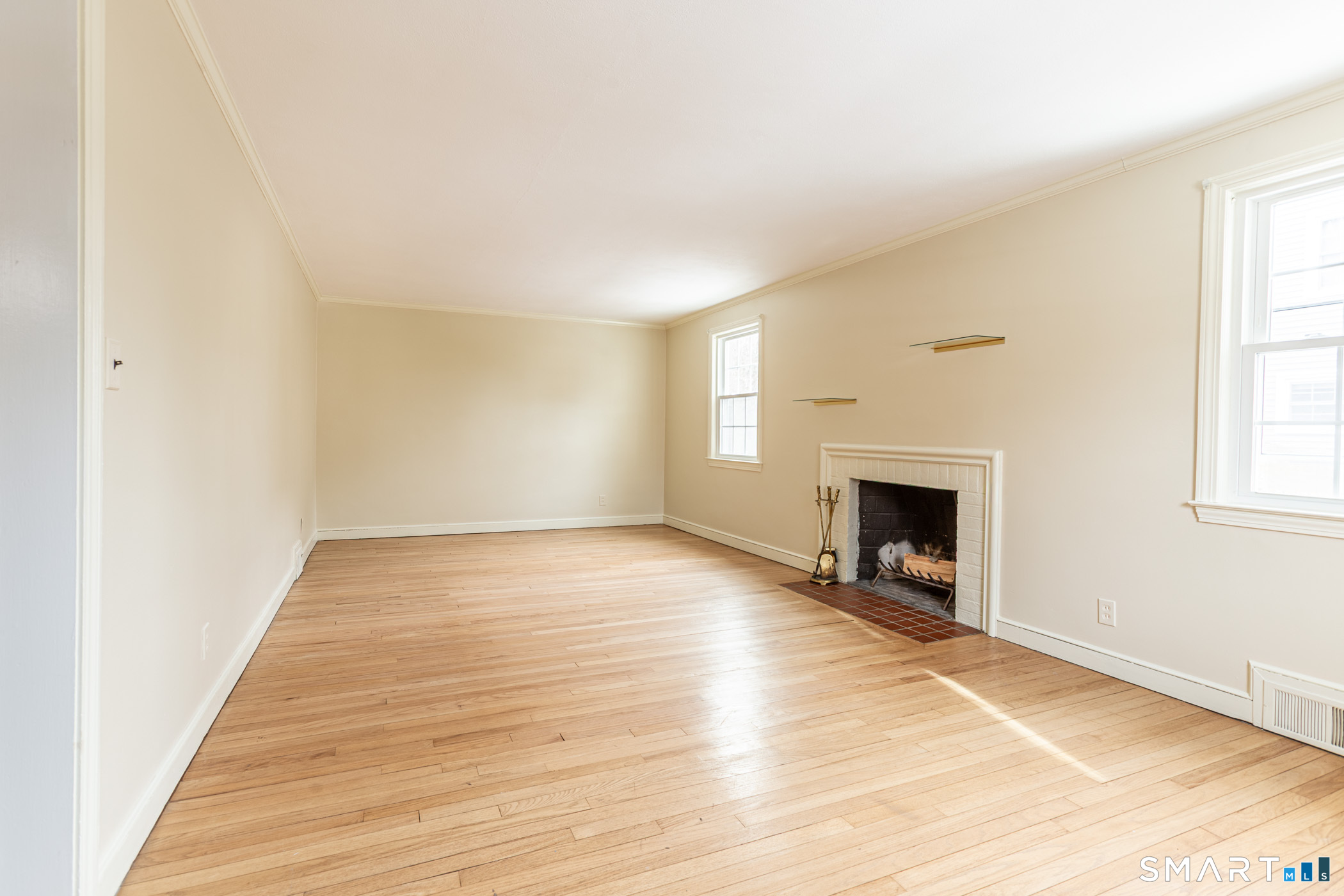 5 Lawler Road West Hartford, CT 06117 - Photo 5 of 33 a view of empty room with wooden floor and fireplace