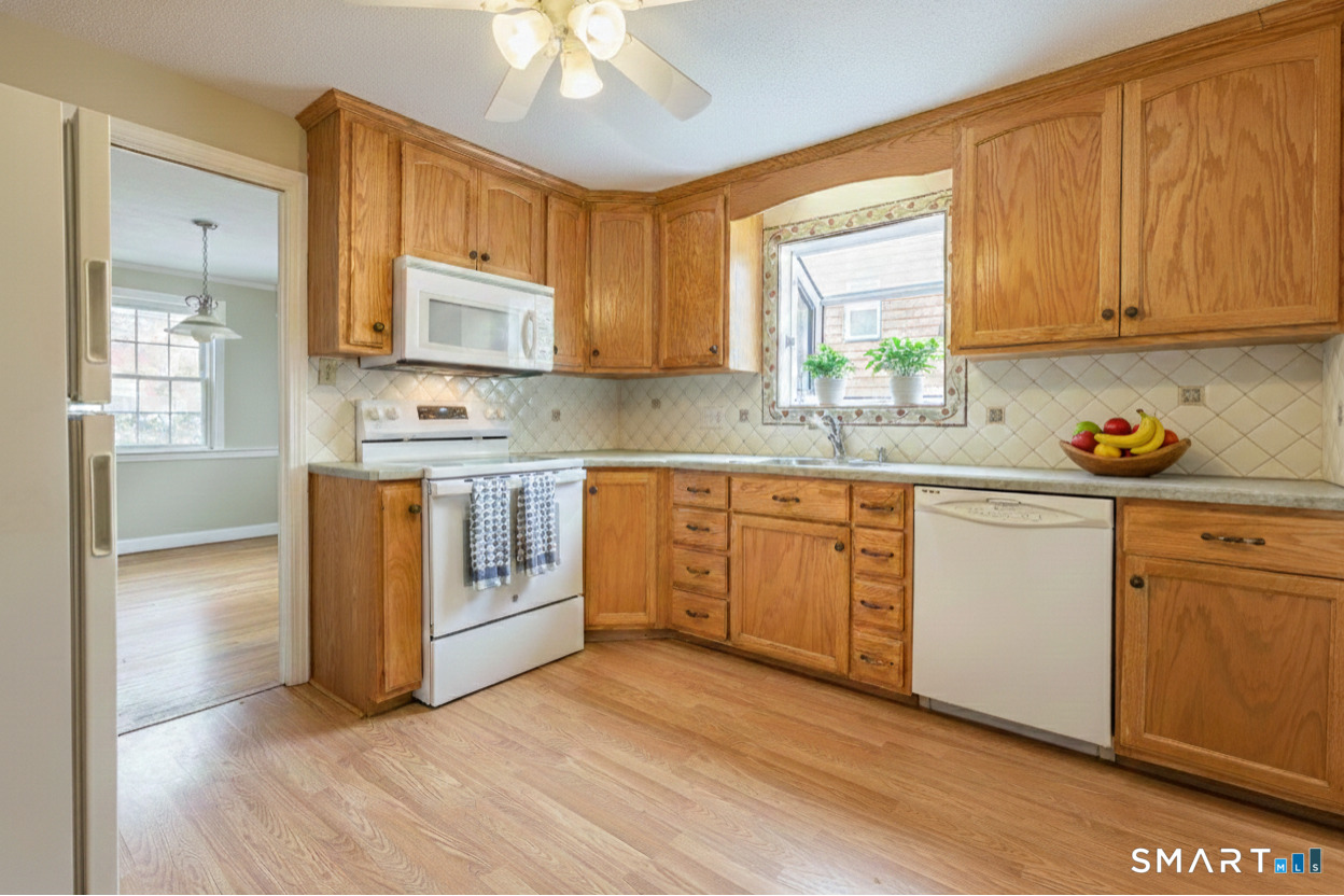 5 Lawler Road West Hartford, CT 06117 - Photo 10 of 33 a kitchen with stainless steel appliances granite countertop a stove a sink dishwasher and a microwave oven with cabinets
