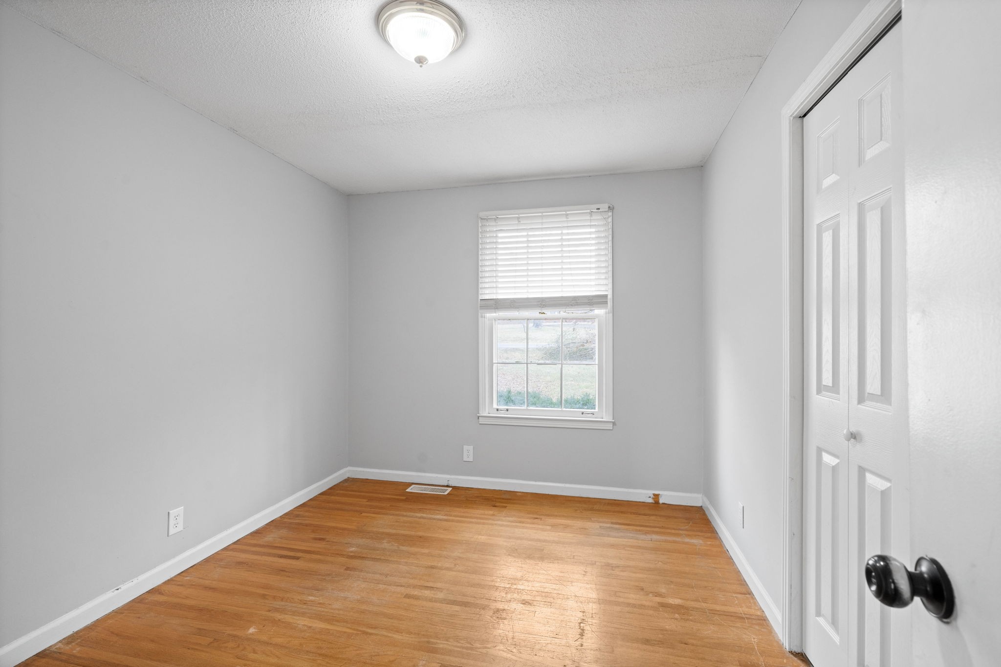 234 Old Trenton Road Clarksville, TN 37040 - Photo 16 of 25 a view of an empty room with wooden floor and a window