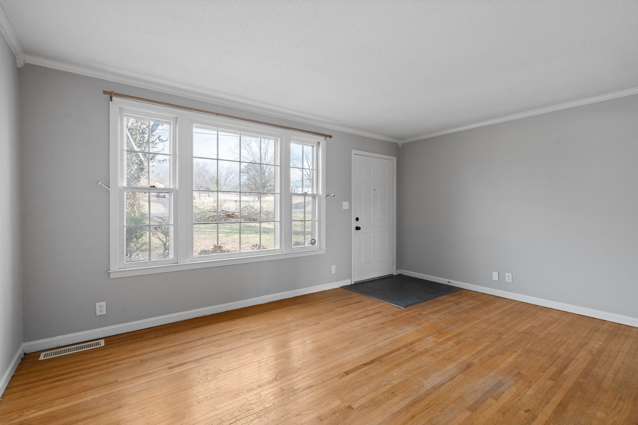 234 Old Trenton Road Clarksville, TN 37040 - Photo 6 of 25 an empty room with wooden floor and windows