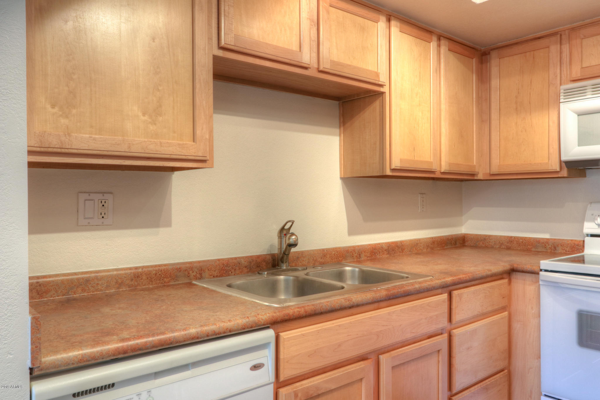 8256 East Arabian Trail, Unit 237 Scottsdale, AZ 85258 - Photo 11 of 31 a kitchen with a sink and cabinets