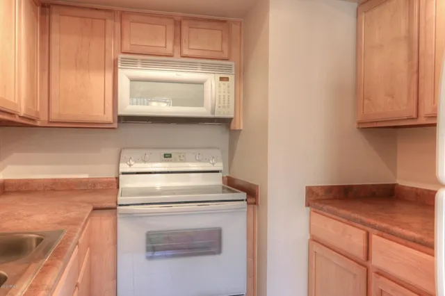 a stove top oven sitting inside of a kitchen