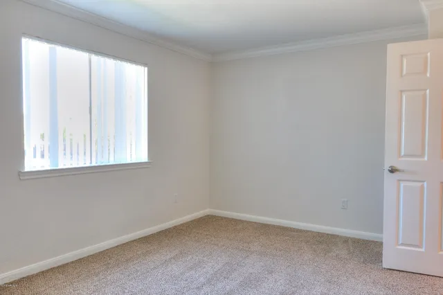 a view of an empty room and a window