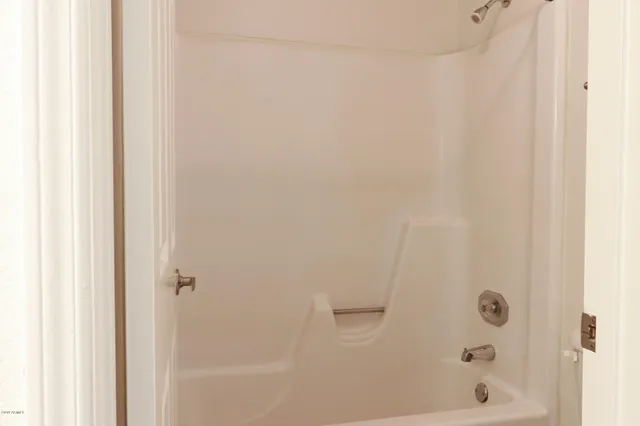 a bathroom with a glass shower door