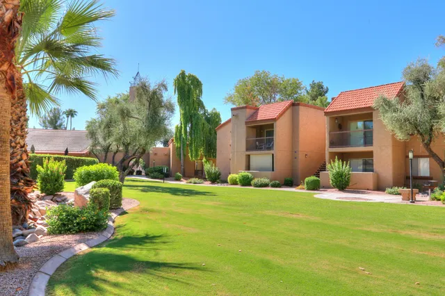front view of house with a yard and potted plants
