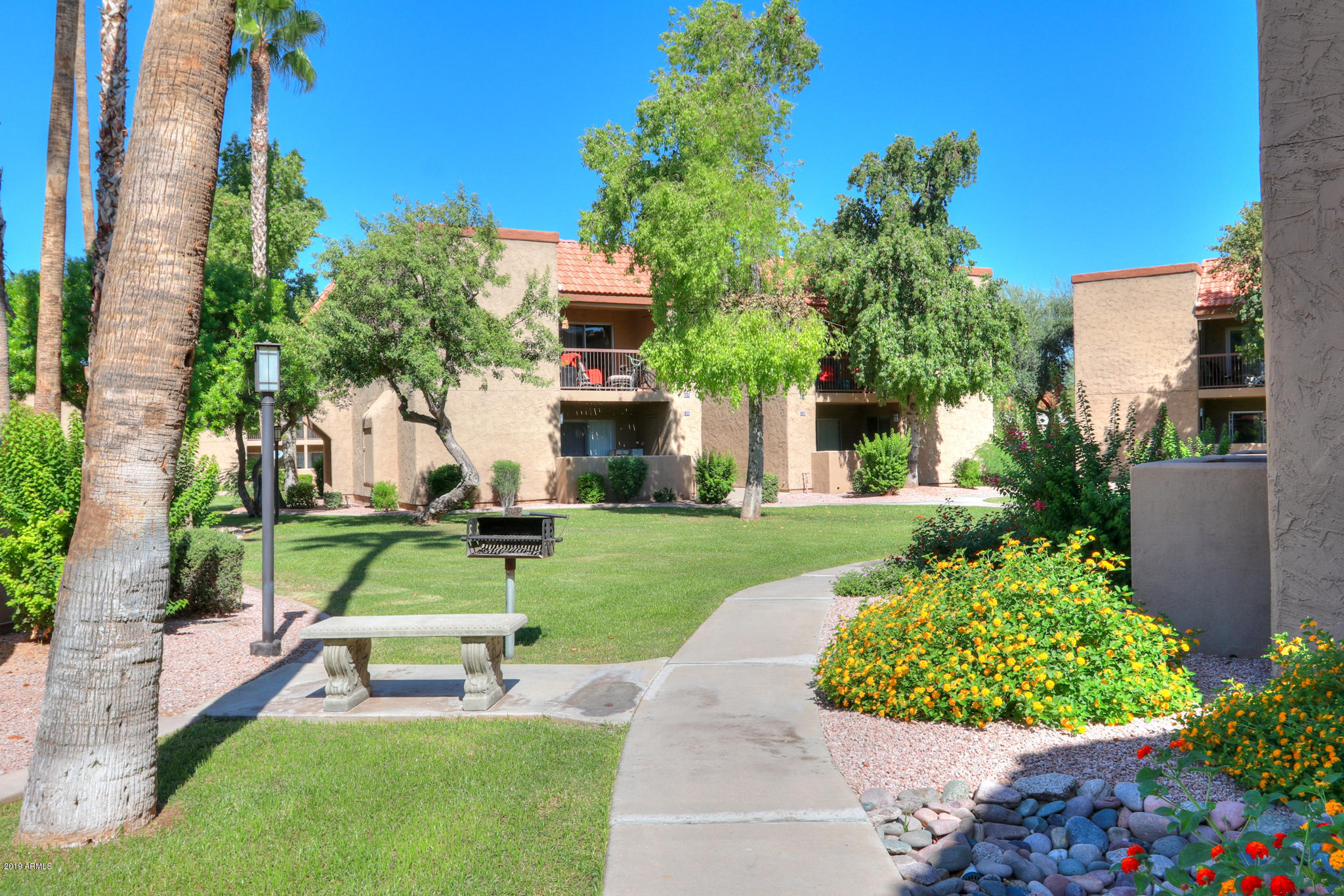 8256 East Arabian Trail, Unit 237 Scottsdale, AZ 85258 - Photo 29 of 31 a view of a chair and table in the garden